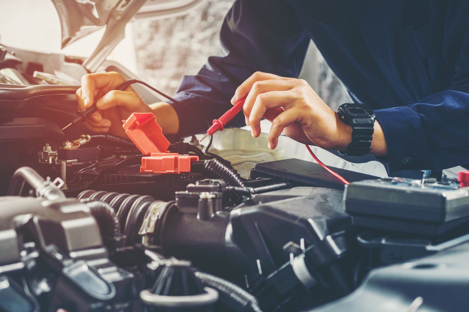 Auto Mechanic Checking Car Battery Voltage — Chula Vista, CA — Bonita Point Auto Care 76 A mechanic checking a car’s battery at an auto repair shop near Spring Valley, CA