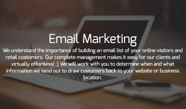 A laptop is sitting on a table with the words email marketing written on it