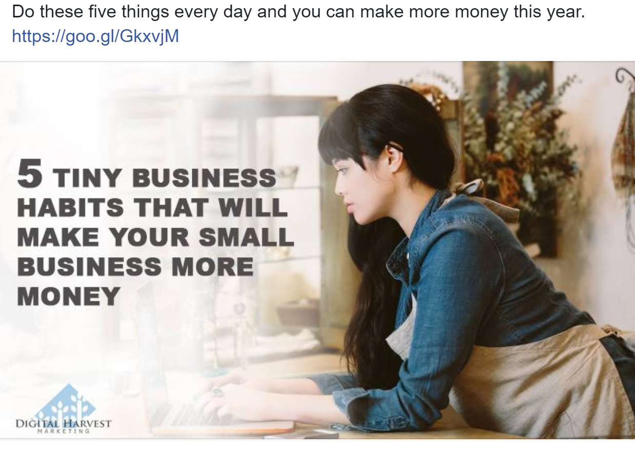 A woman is sitting at a table using a laptop computer.