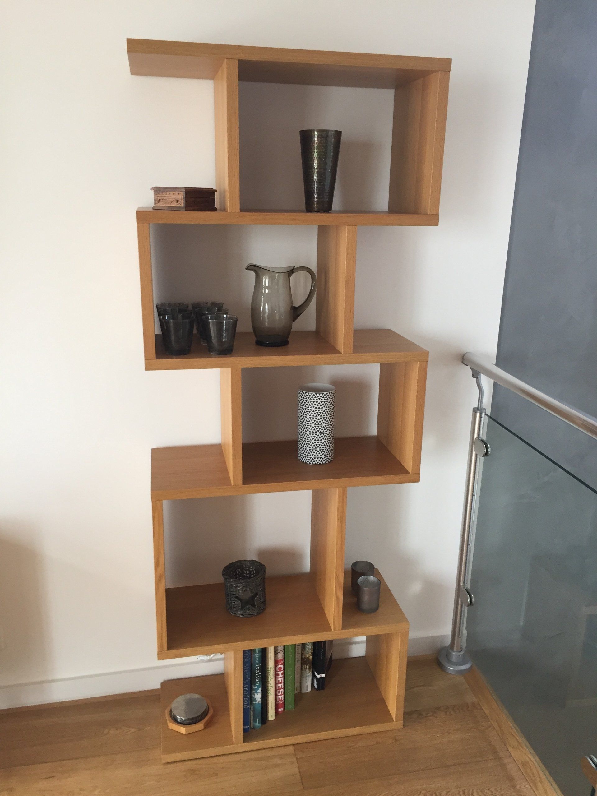 A wooden shelf with a pitcher on top of it