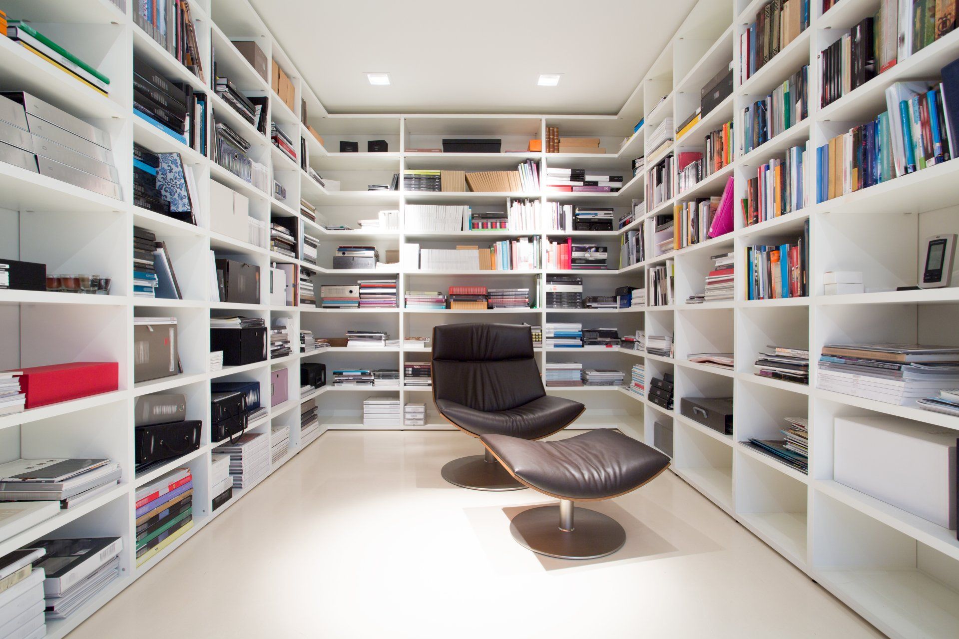 A library with lots of books and a chair