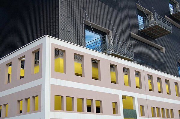 A building with yellow windows and a fire escape