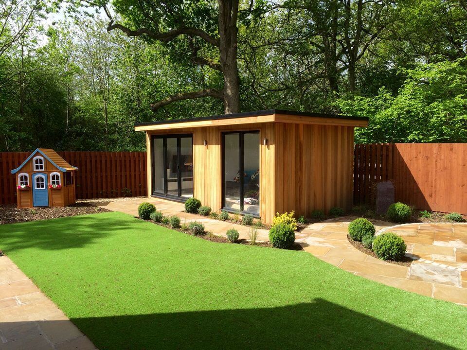 back yard garden with thick grass and small house