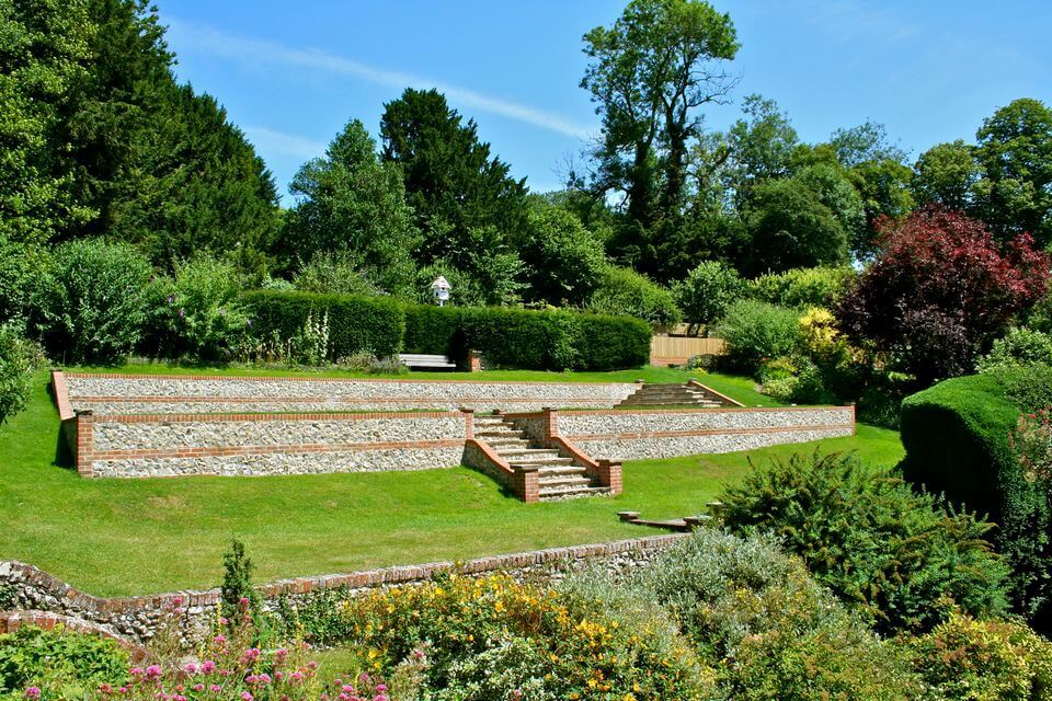 rock wall with steps in a back yard garden