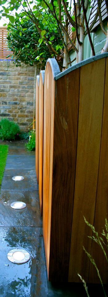 tall wooden pot in a modern small garden