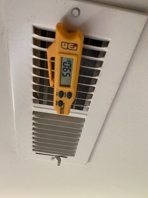 A yellow ue thermometer is hanging from the ceiling