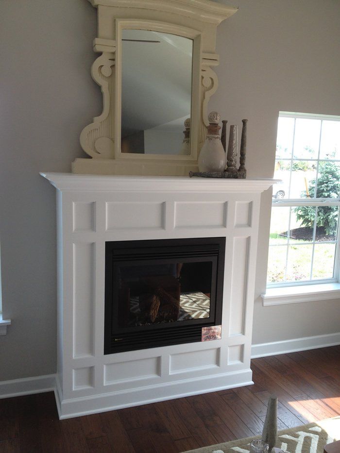 White mantel and wood burning fireplace