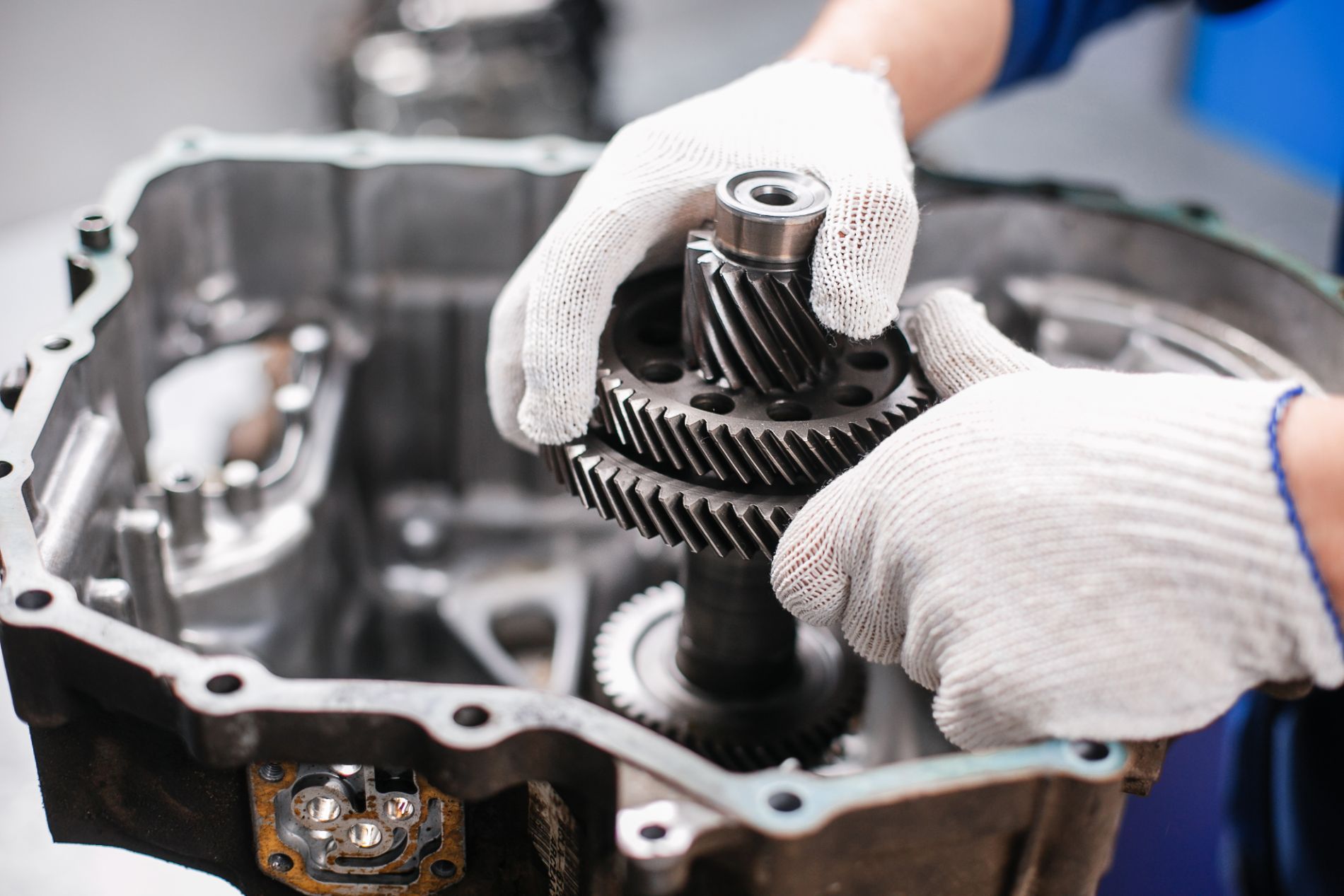 Mechanic's hands holding a transmission gear assembly, transmission rebuilding service in Cincinnati, OH