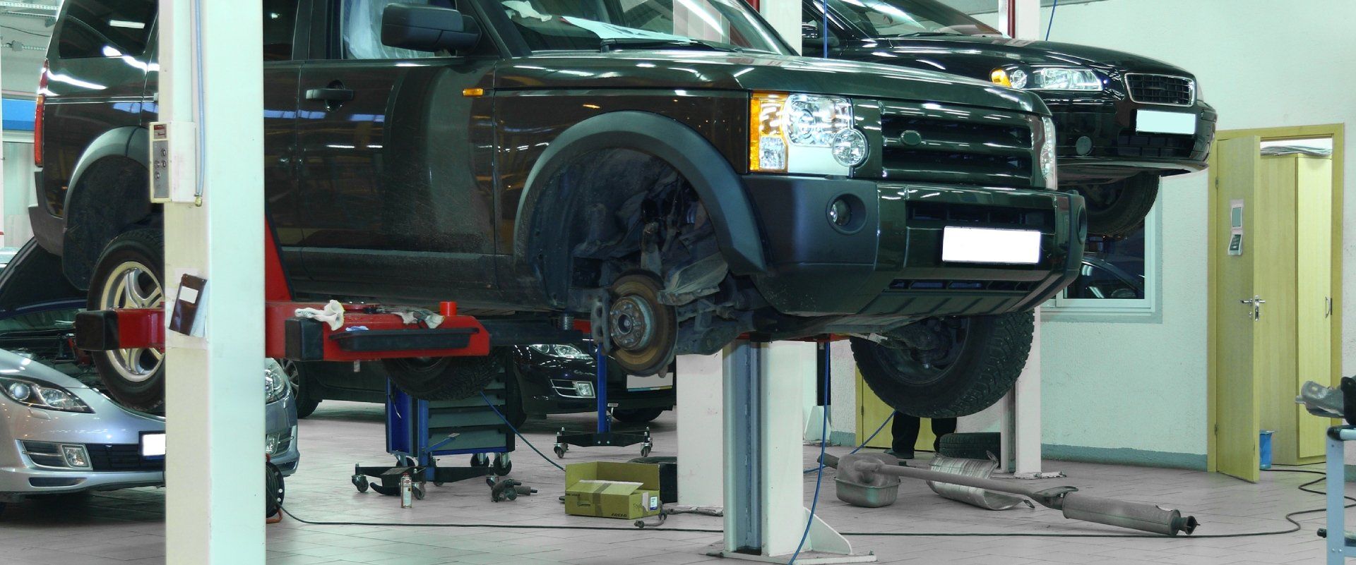 SUV raised on a hydraulic lift for auto repair service in Cincinnati, OH