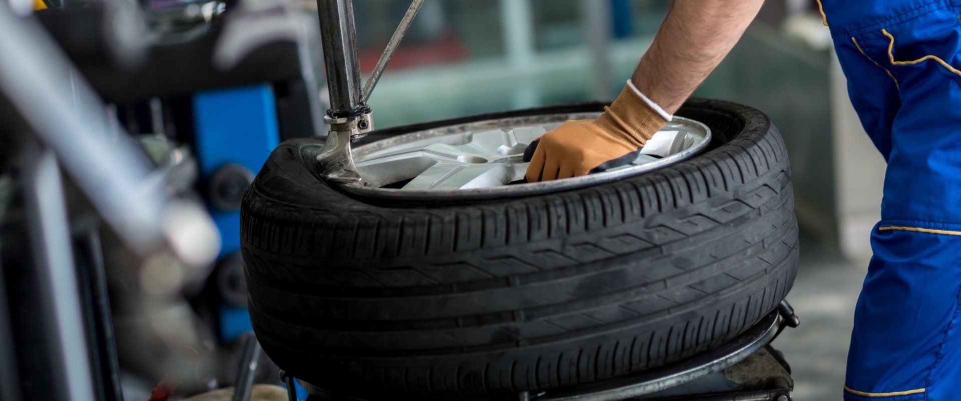 Technician mounting a tire onto a wheel rim, tire installation and repair service in Cincinnati, OH