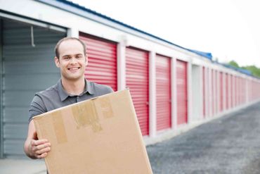 Storage Units — Man Holding a Box in Waterloo, IA Storage Units — Man Holding a Box in Waterloo, IA