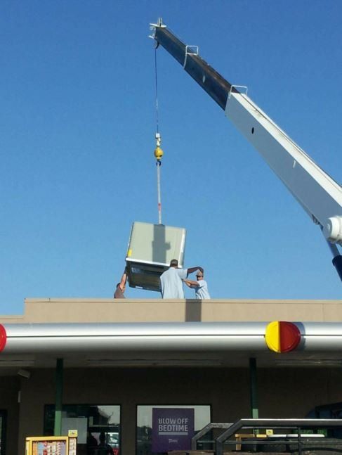 Workers moving HVAC