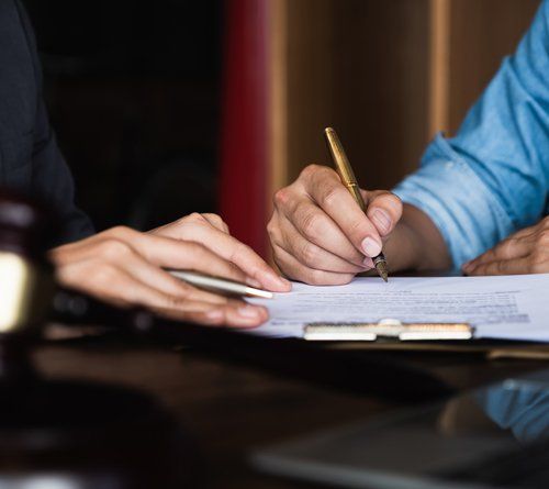 Executive Hands Holding a Pen — De Pere, WI — One Law Group S.C Executive Hands Holding a Pen — De Pere, WI — One Law Group S.C