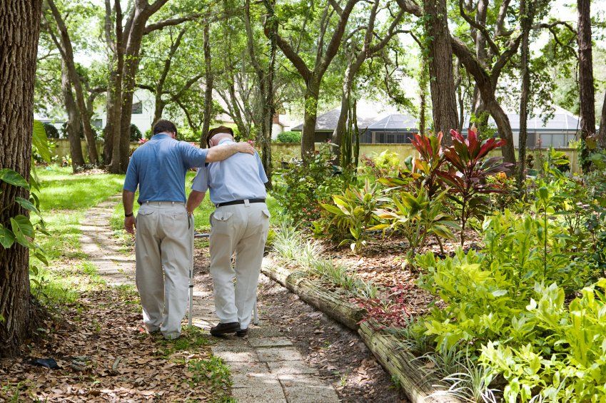 Adult Son Walking with His Senior Father — De Pere, WI — One Law Group S.C Adult Son Walking with His Senior Father — De Pere, WI — One Law Group S.C