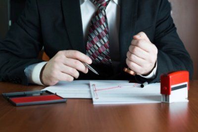 Notary public stamping a document - MA,USA Notary public stamping a document - MA,USA