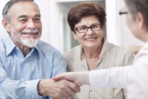 happy couple meeting attorney A couple getting assistance with their wills in Canberra