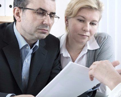 couple reading paperwork reading papers