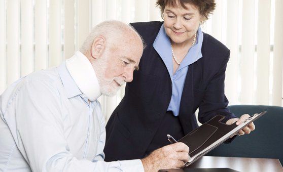 injured man signing paperwork personal injury