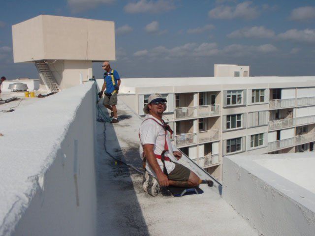Two Men Working On The Roof — Oakland Park, FL — Watertite Gutter Company