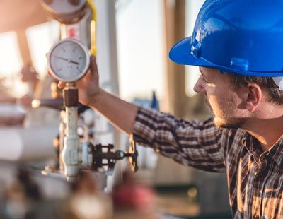 Certified Propane Technician — Man Checking a Propane Tank in Lipan, TX Certified Propane Technician — Man Checking a Propane Tank in Lipan, TX
