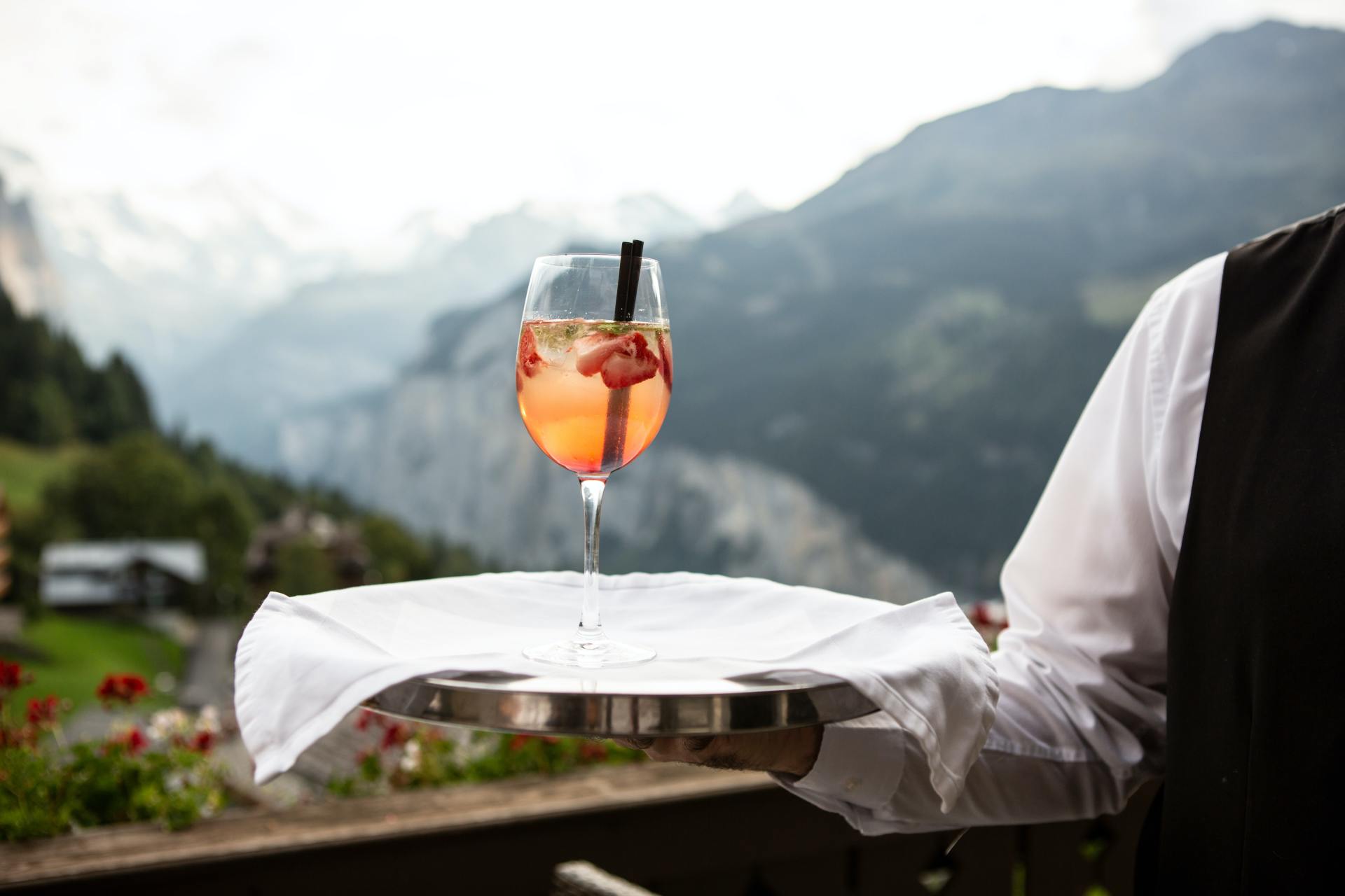 Waiter balancing wine glasses on a tray, ready to serve