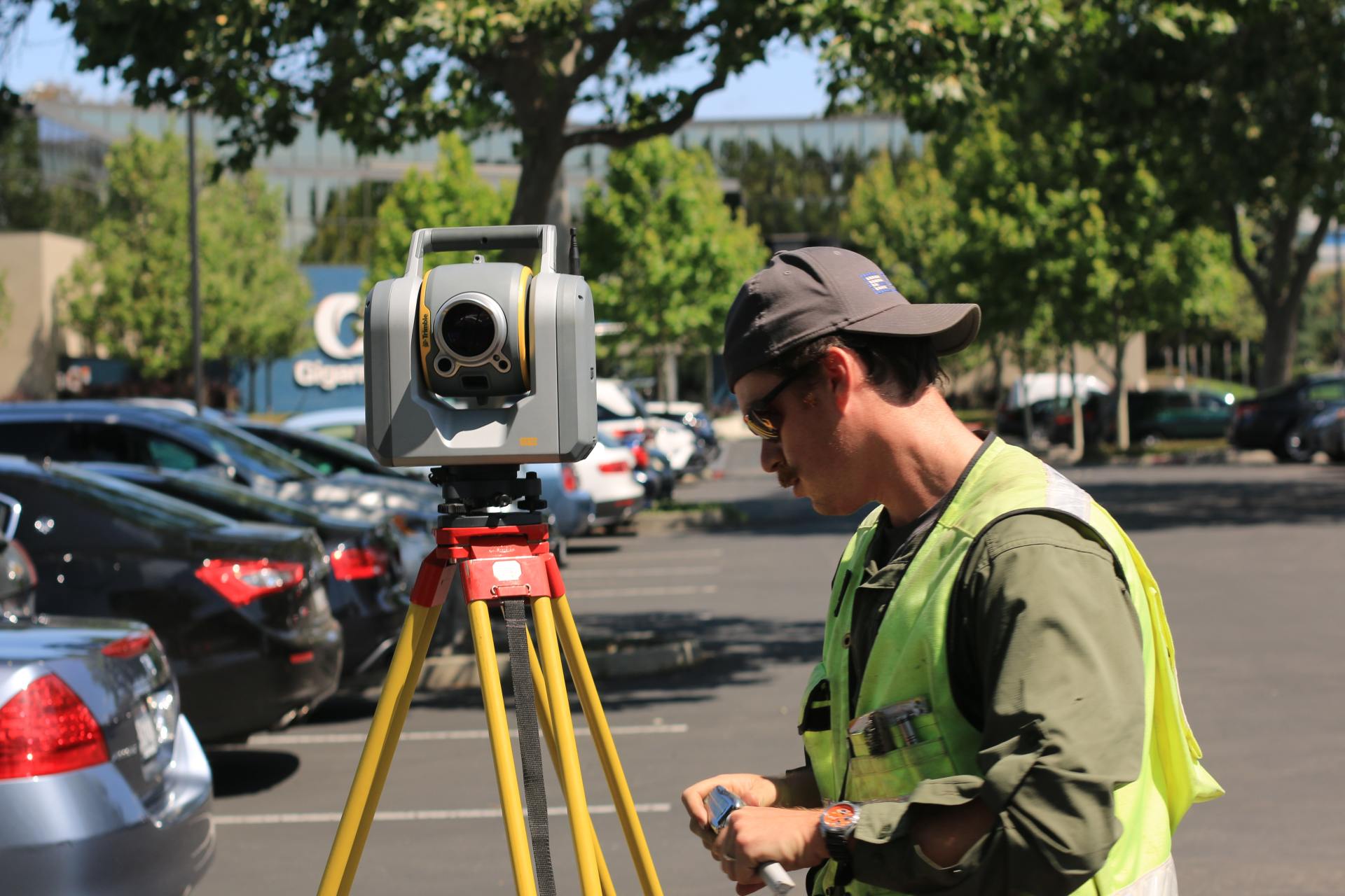 A ground Surveyor looking at the reading from his machine.