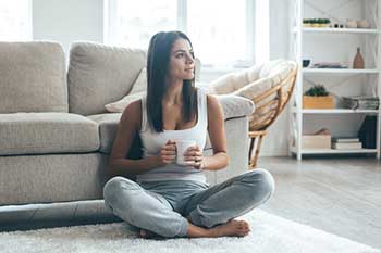 Rug Company — Woman Sitting on Carpet in Wilmington, DE