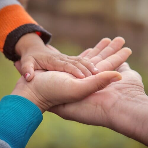 Child's Hand Touching Parents' Hand — Legal Aide in Merced, CA Child's Hand Touching Parents' Hand — Legal Aide in Merced, CA