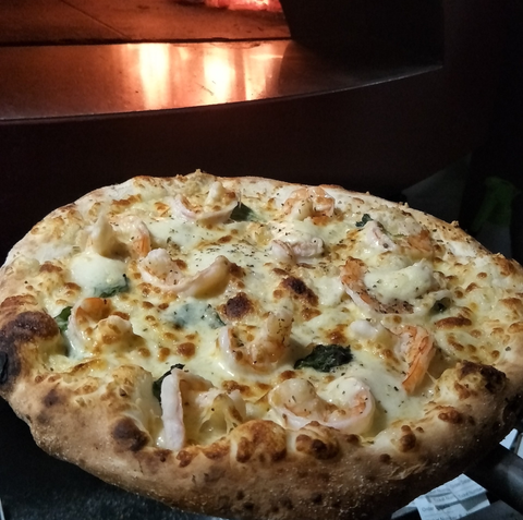 View of a veg pizza put on a wooden table