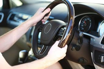 Power Steering someone gripping a steering wheel