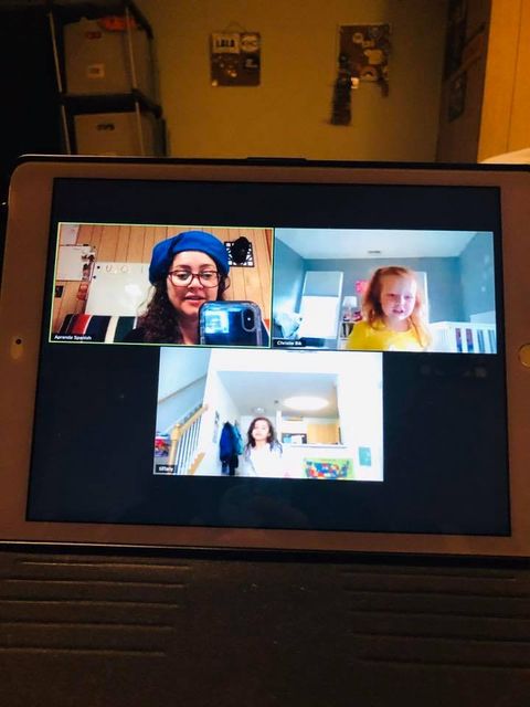 A group of people are having a video call on a tablet