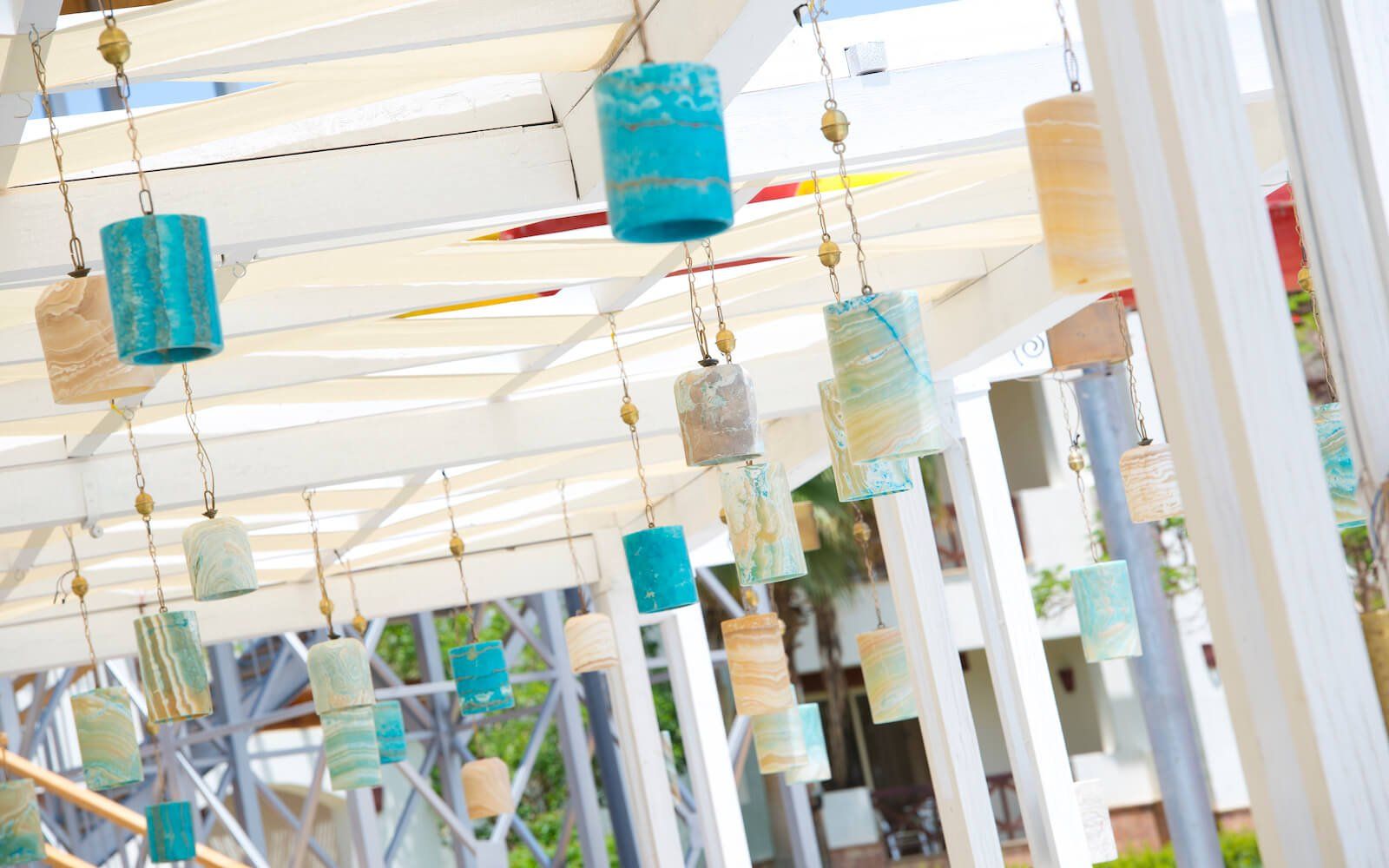 Alfresco dining area with cozy furniture and hanging lanterns at the resort.