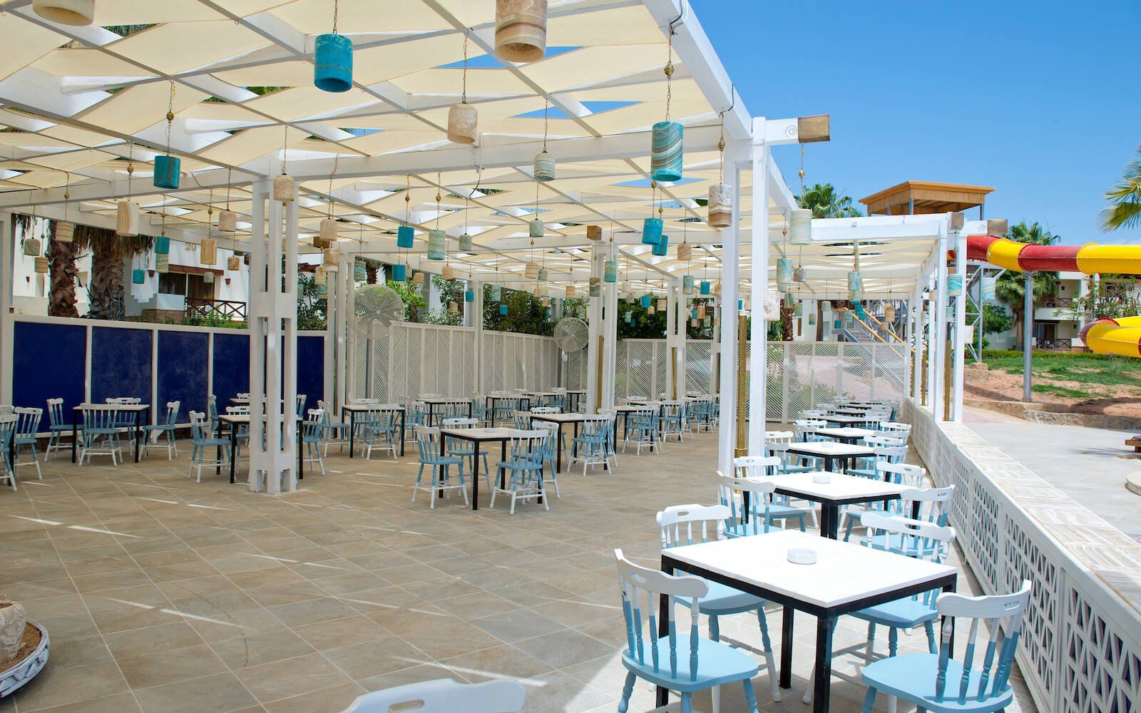 Resort dining area with open-air setup and stylish blue-and-white theme.