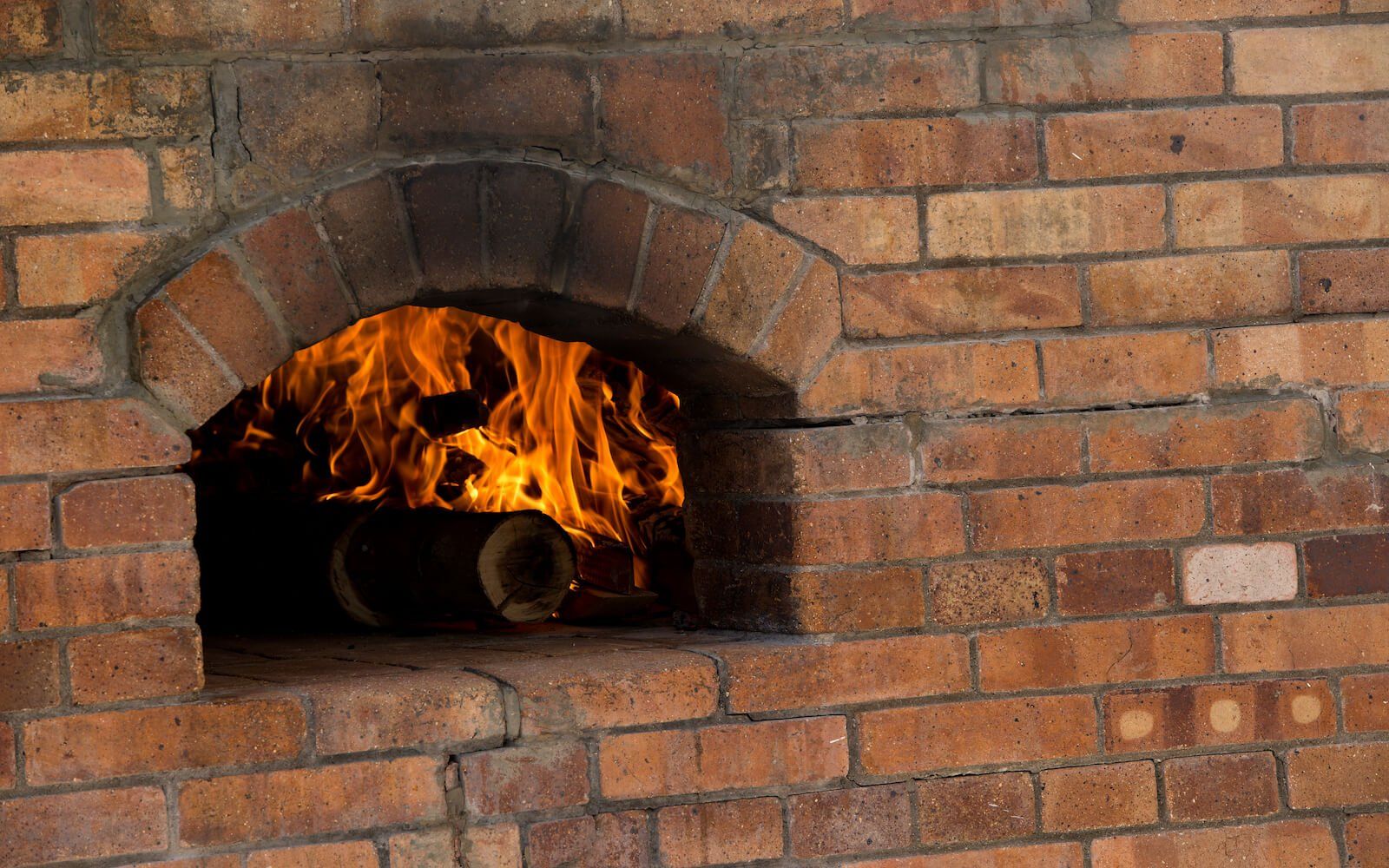 Traditional brick oven used for baking fresh pizza at the resort.