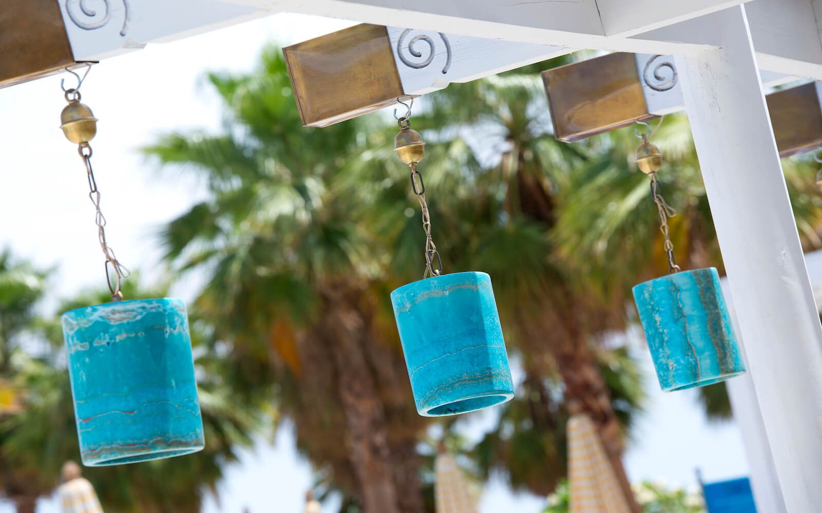 Alfresco dining area with cozy furniture and hanging lanterns at the resort.