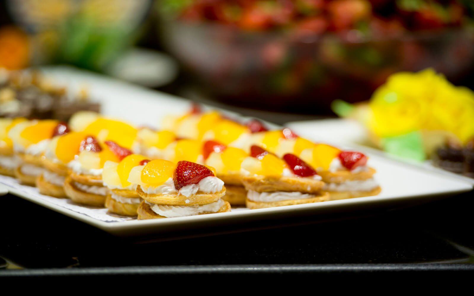 Close-up of dessert trays with small cakes and sweets.