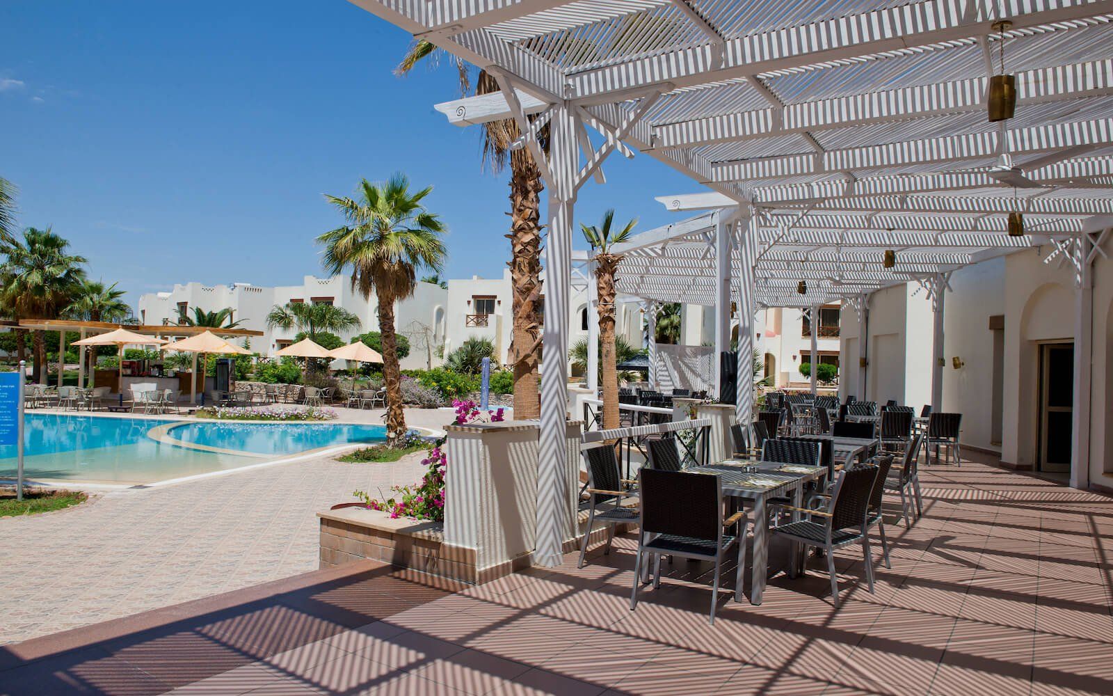 Resort dining area with open-air setup and stylish blue-and-white theme.