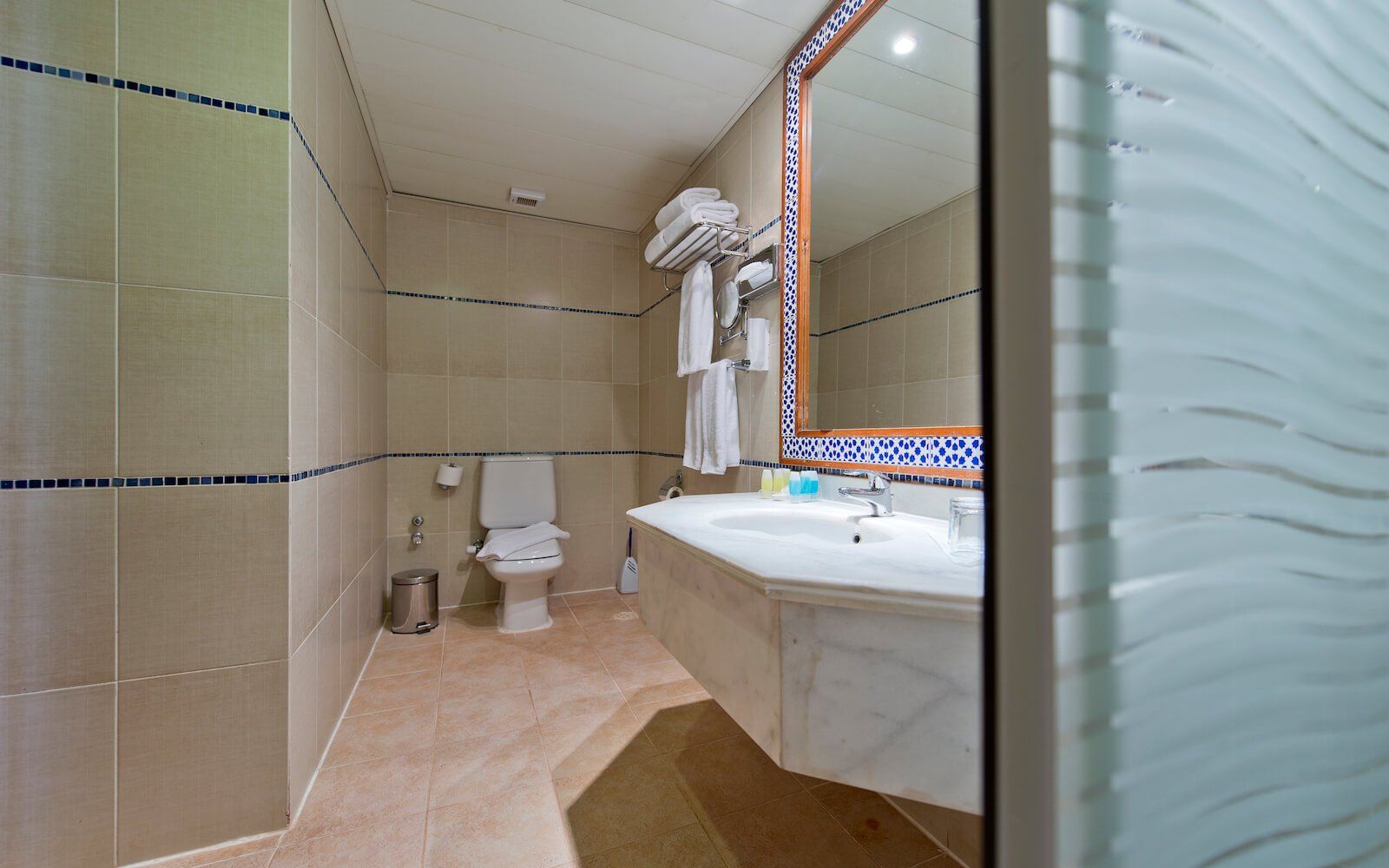 Clean and well-lit bathroom with stylish fixtures and tiled walls.