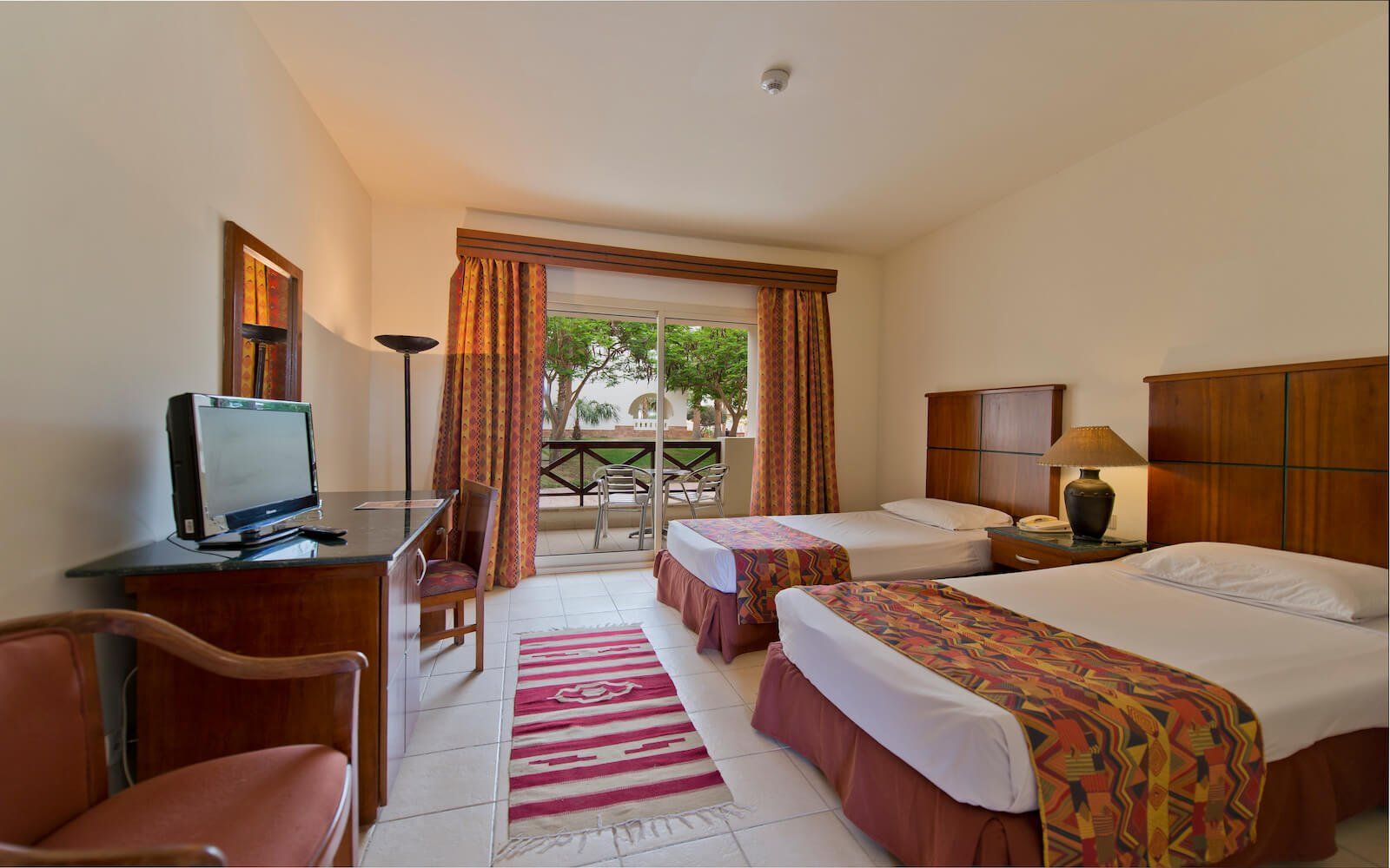 Comfortable bedroom with garden view at Amphoras Aqua