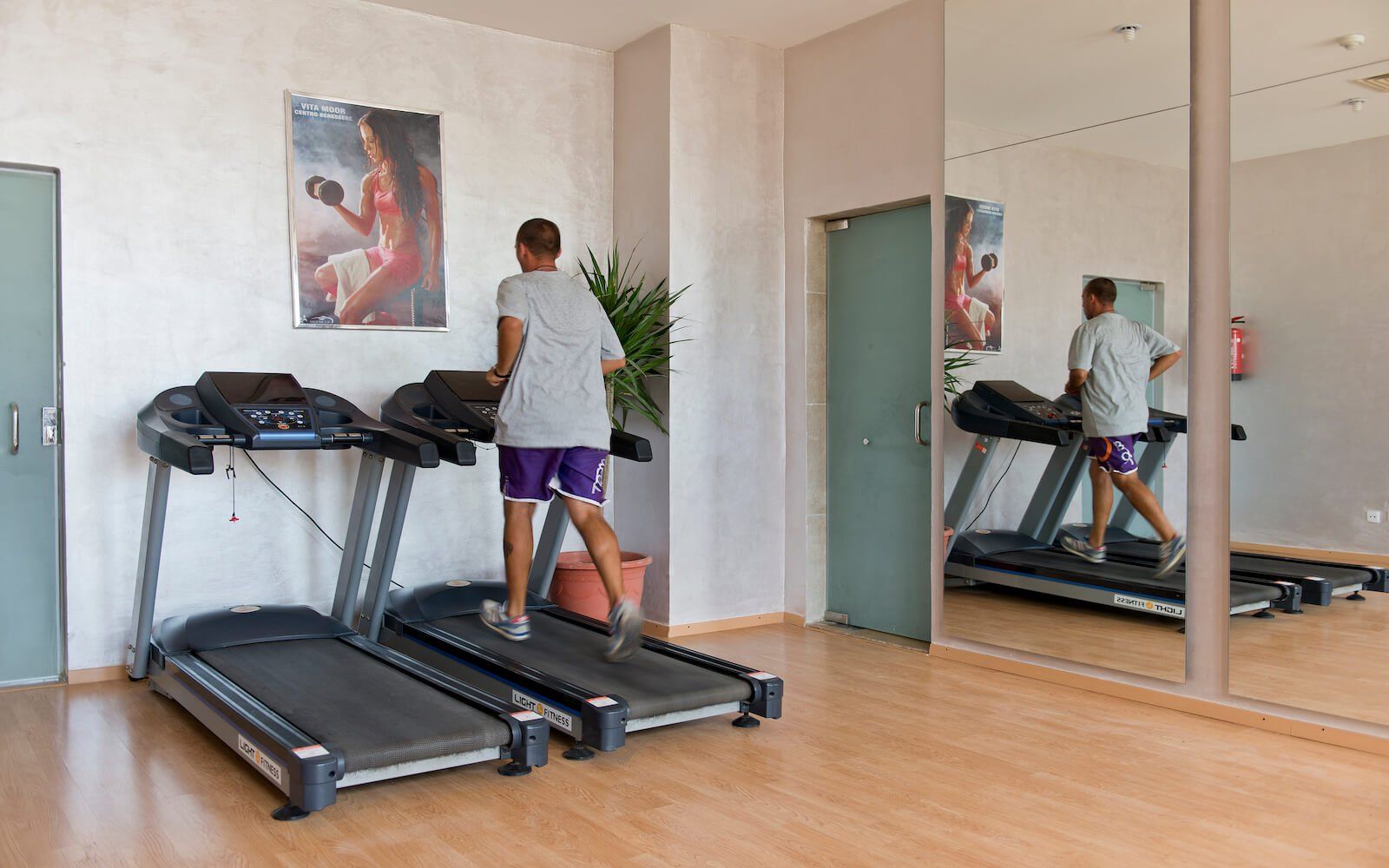 Guest working out on a treadmill at the resort gym. 