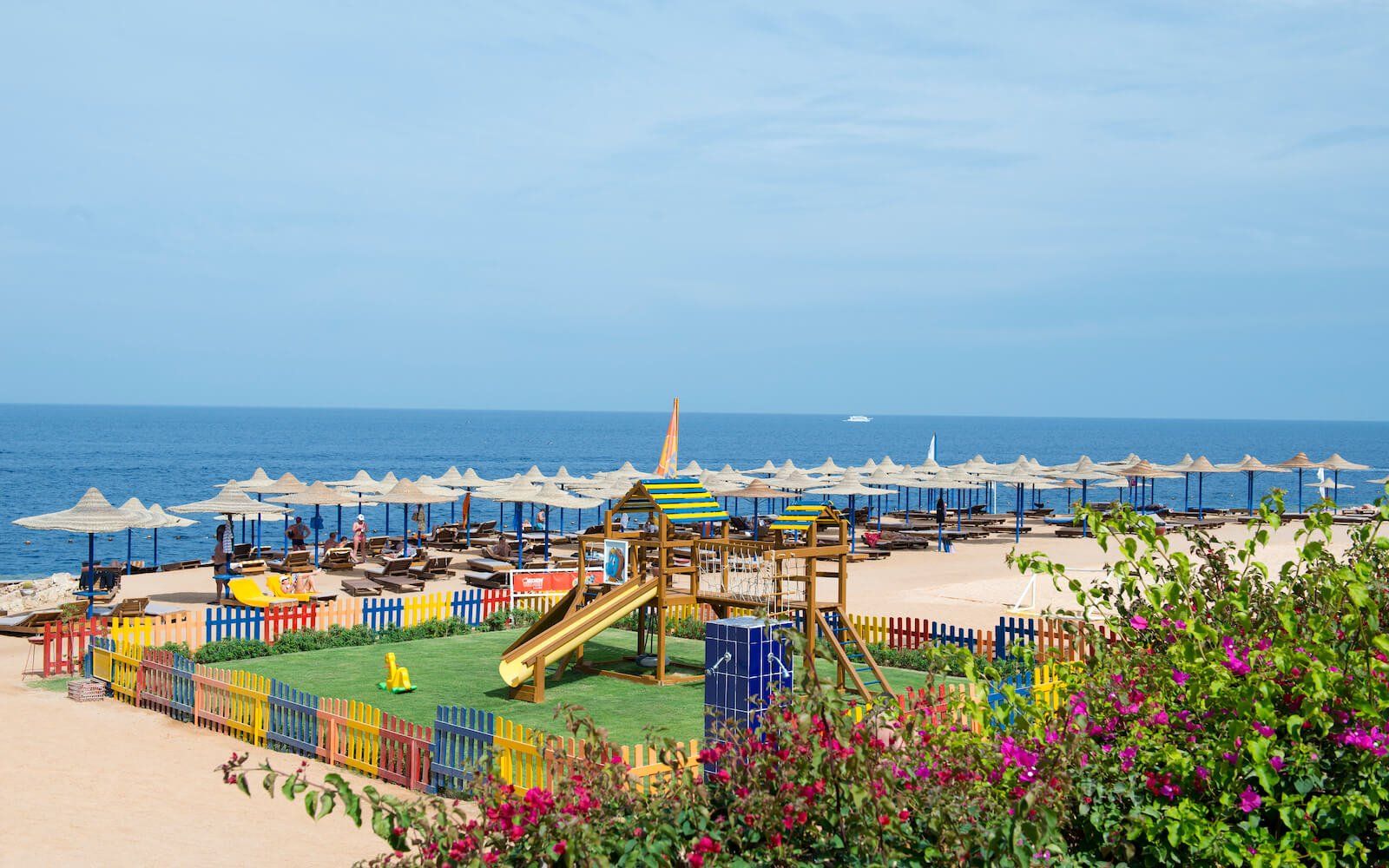 Wide shot of the kids’ play area at the resort, with the beach and Red Sea in the background.