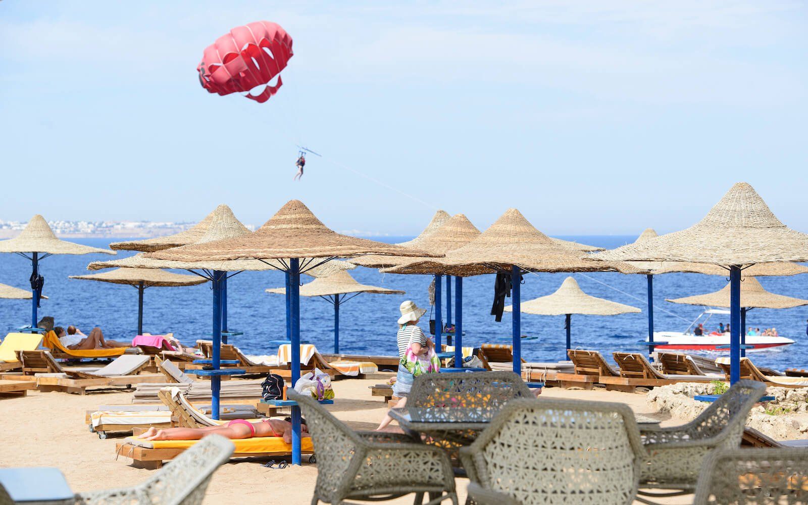 Private beach with sunbeds, umbrellas, and crystal-clear waters.