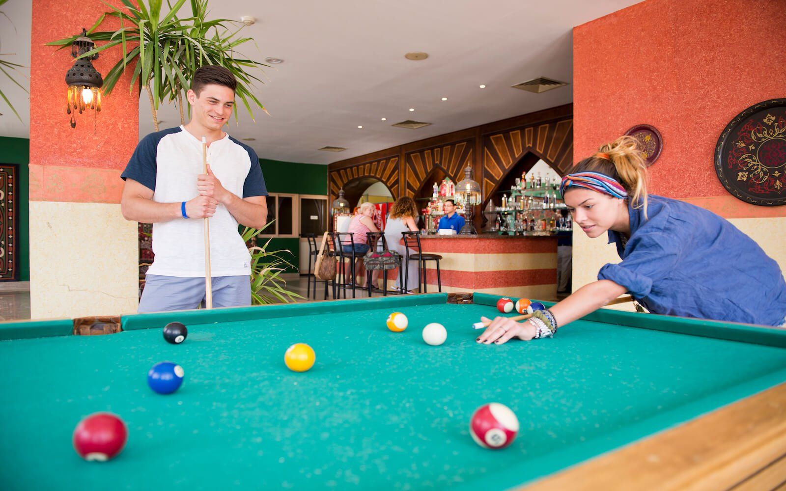 Guests enjoying a game of billiards in the resort's recreation area.