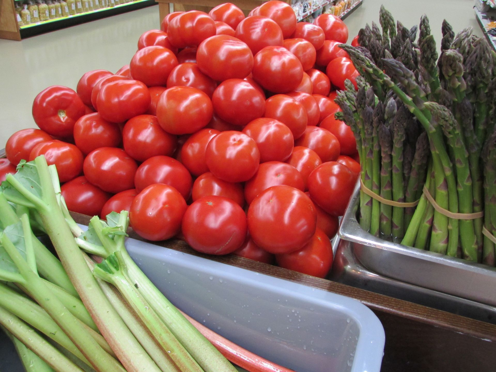 Girl selecting from fresh garden produce in grocery shop in Tomah, WI
