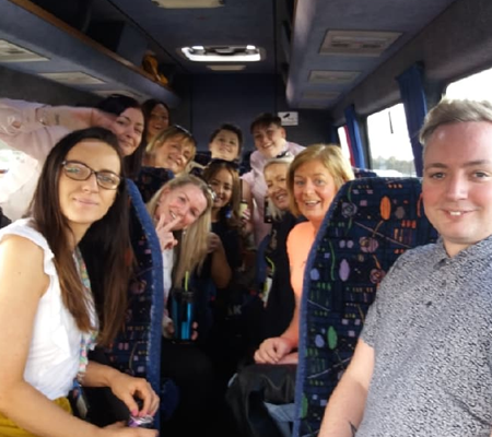 A family enjoying themselves on a minibus