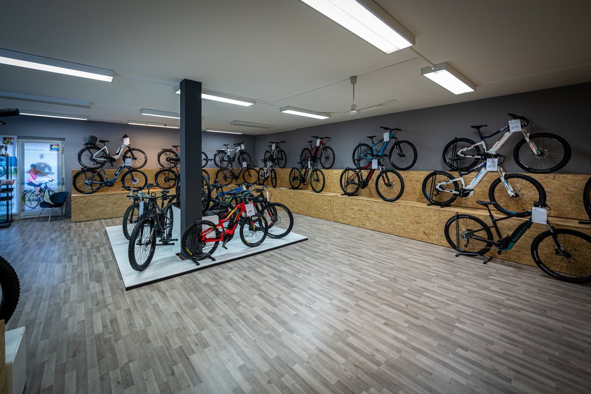A large room filled with lots of bicycles on display.