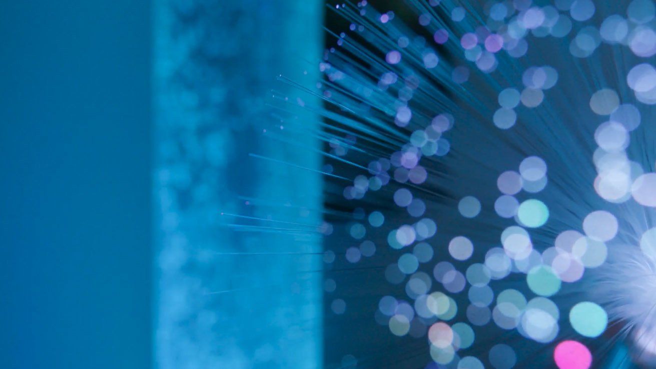 A close up of a fiber optic cable with a blue background.