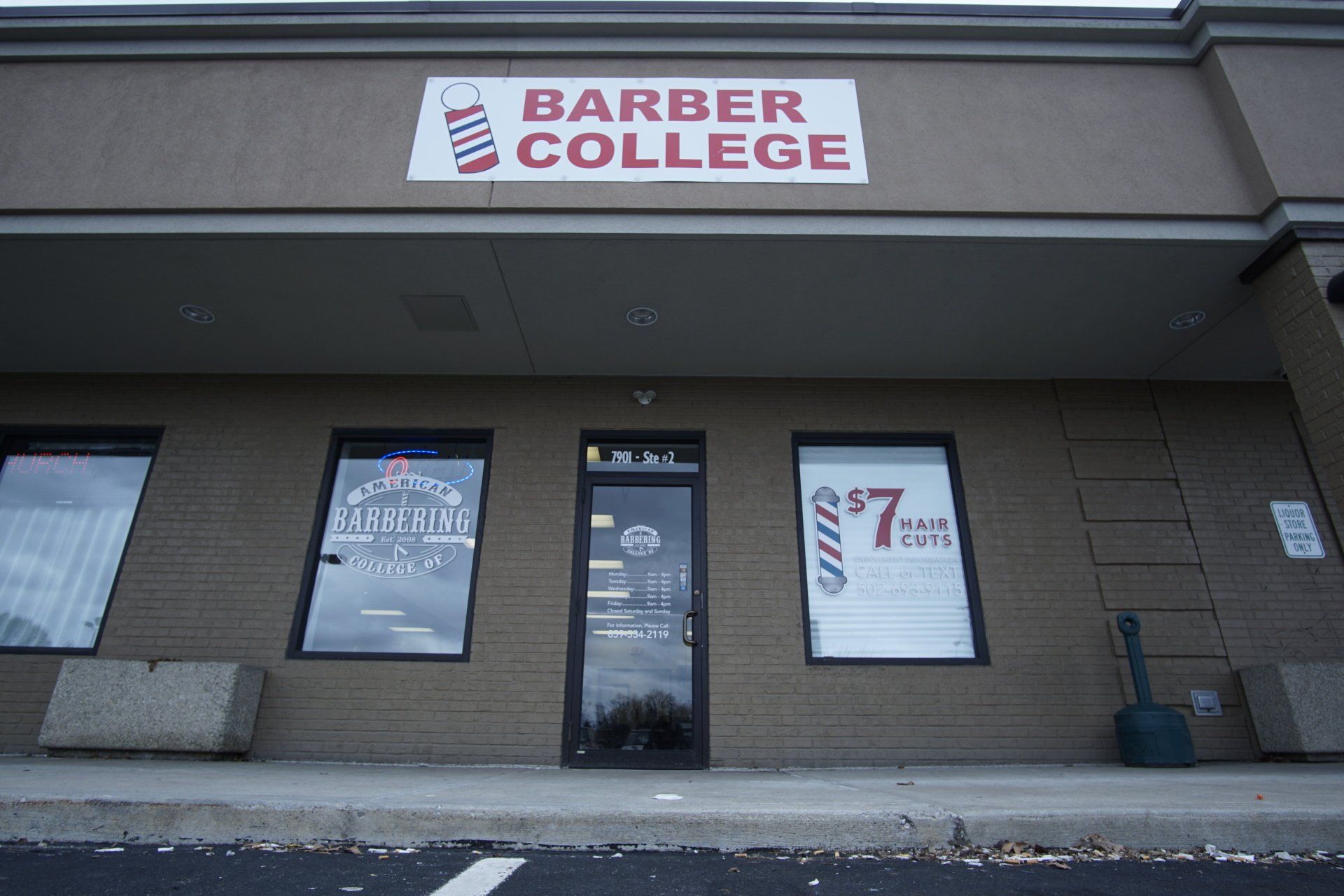 A building with a sign that says barber college