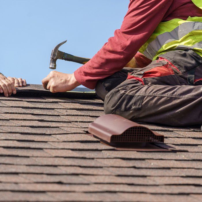 Fixing Roof Using Hammer — Lakewood, CO — Watershed Roofing & Restoration