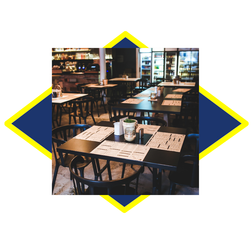 a restaurant with tables and chairs set up for a meal .